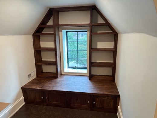 Walnut reading nook with angled bookcases